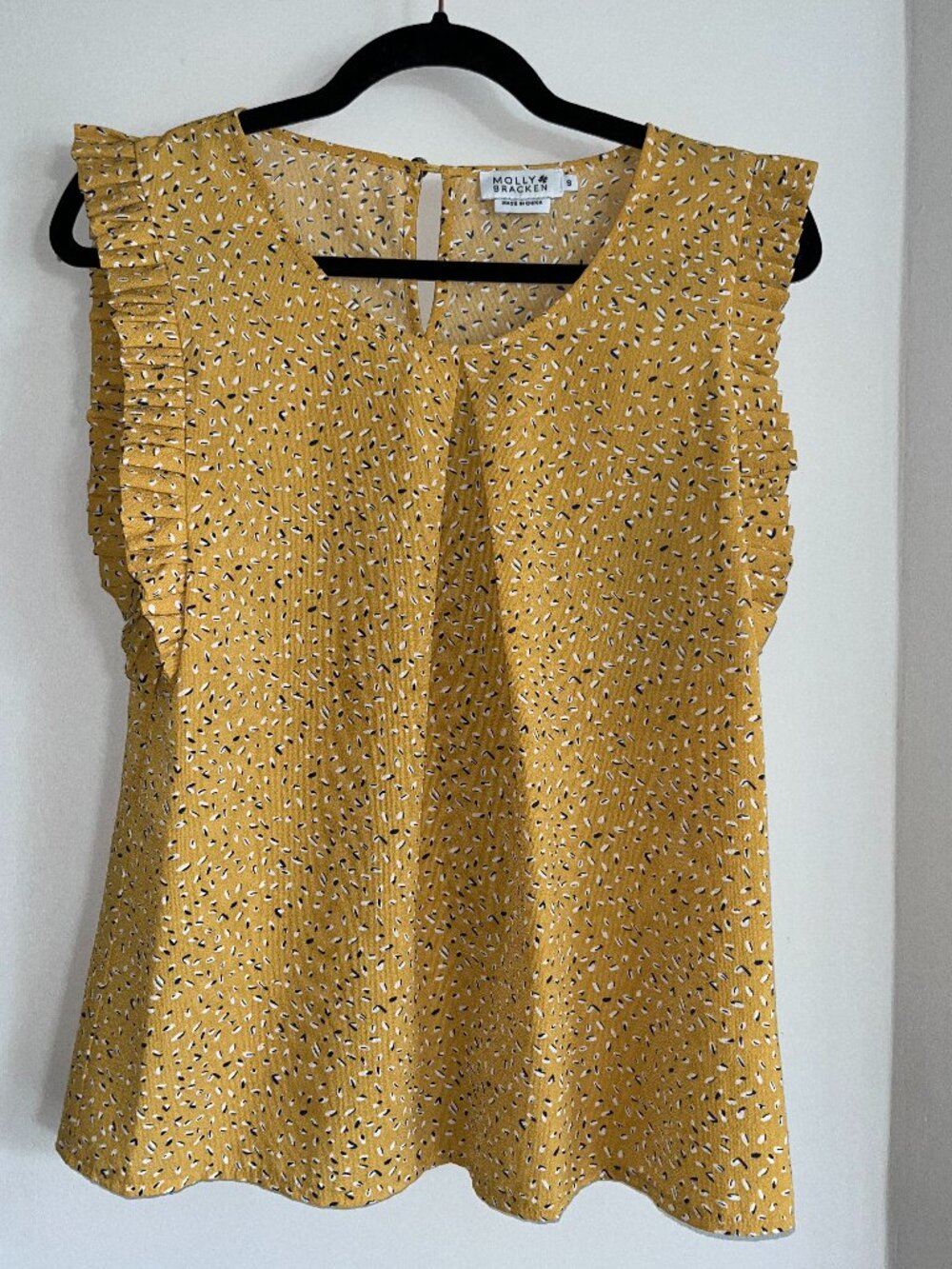 Yellow ruffle sleeveless blouse